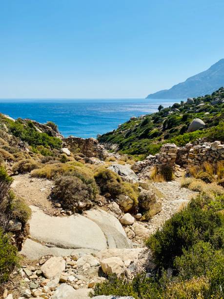 Rocky path down to the sea in Ikaria, Greece stock photo