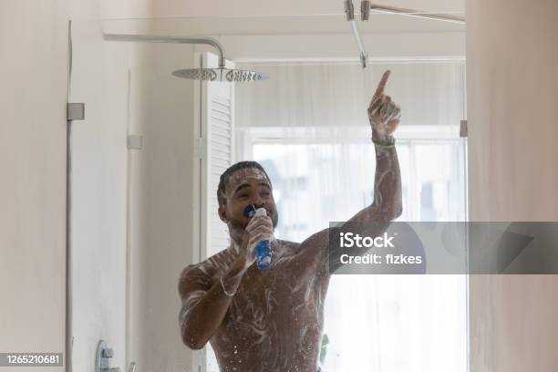 Positive African American Man Having Fun In Bathroom Singing Stock Photo - Download Image Now