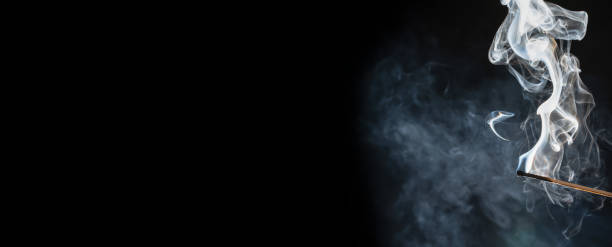 istock burnt match with beautiful smoke cloud isolated on black background 1265212385