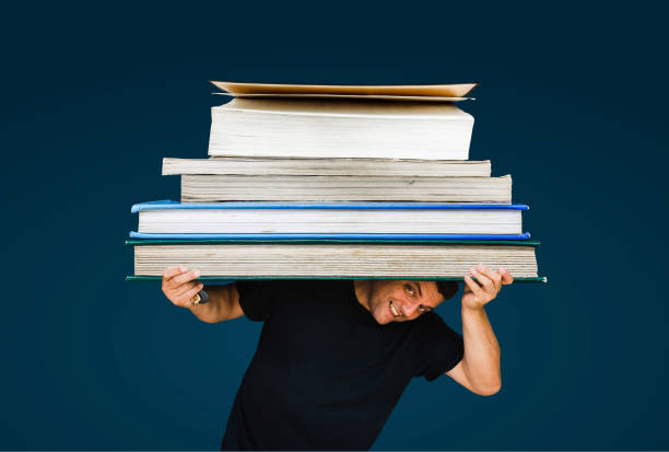 istock man holding a huge books 1265215692