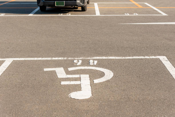 istock Handicapped symbol / icon on empty space Disabled Parking  reserved for disabled people 1265216750