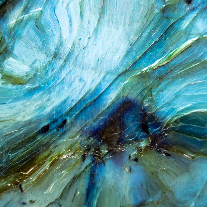 This is a macro photo of a textured blue labradorite stone.  I used special to bring out the interesting and surreal like shapes and water like textures.