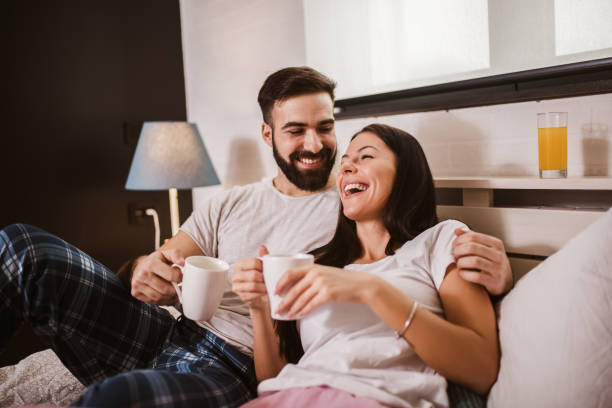 istock Young happy couple drinking coffee in bed at morning 1265219013