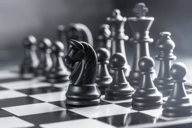 istock black chess on a chessboard. International Chess Day 1265222795