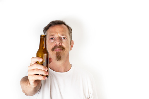 Man holding a bottle of beer in his hand on a white background