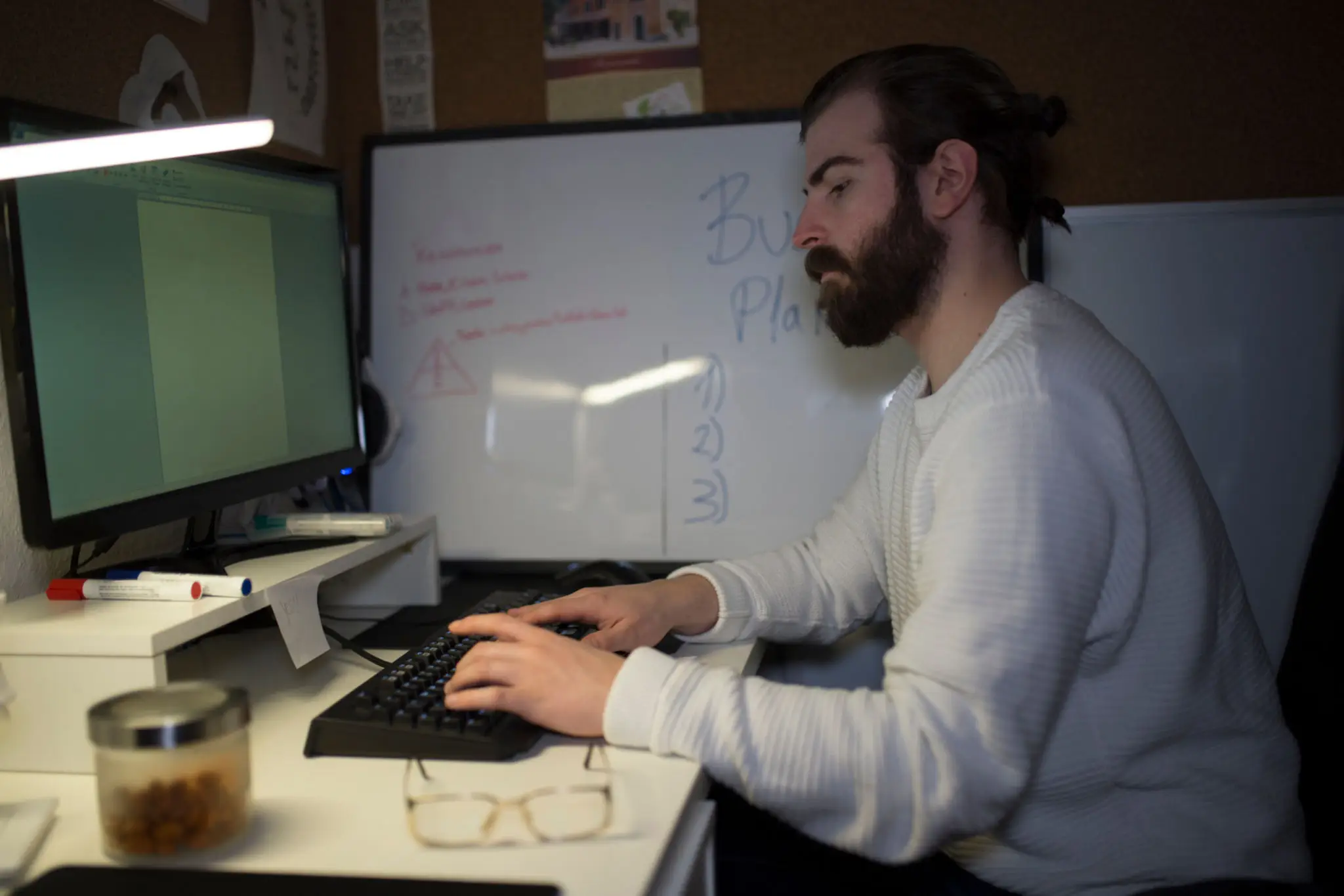 Young man working from home and using computer late night