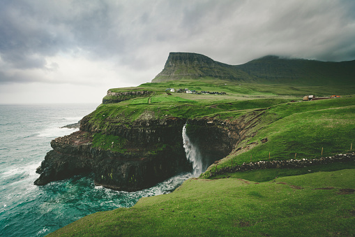 gasadalur village and mulafossur waterfall, faroe islands.