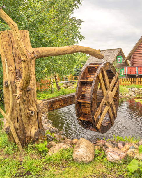 Weathered old water wheel against a stone wall at a disused mill in the picturesque small town of Prince Albert in the heart of the Karoo semidesert region in the Western Cape, South Africa, about five hours' drive from Cape Town.
