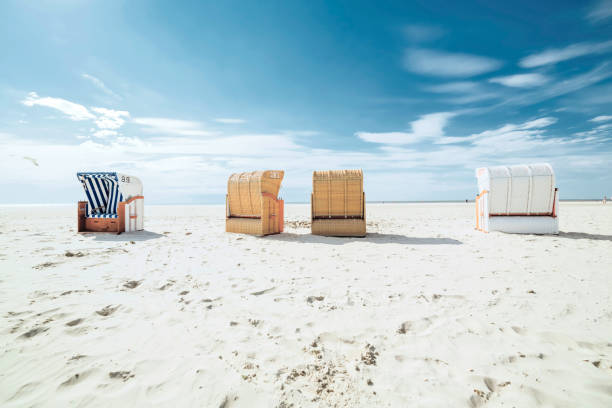istock Formation of roofed wicker beach chairs on white sand beach. 1265227776