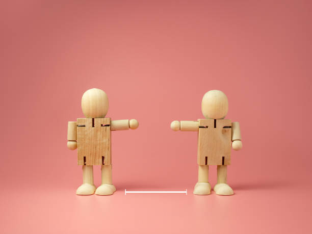 istock Two wooden doll on pink background. keep distance concept. preventive measures. infection control. 1265231128