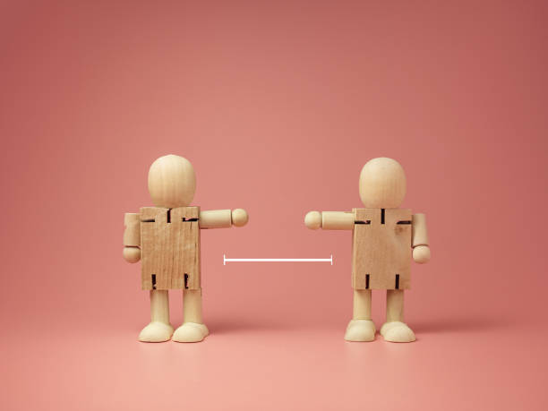 istock Two wooden doll on pink background. keep distance concept. preventive measures. infection control. 1265231129