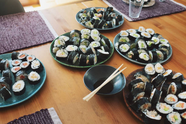 homemade handmade sushi maki pieces on a wooden table in domestic room, ready to eat, beautiful places, setting. - sushi japanese culture food domestic kitchen imagens e fotografias de stock