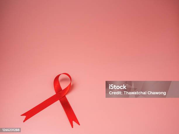 Red Ribbon On Pink Background World Aids Day Concept Symbol Of Human Immunodeficiency Virus Disease Stock Photo - Download Image Now