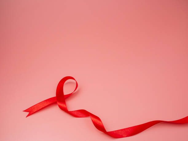 istock Symbol Red ribbon on pink background. 1265231299