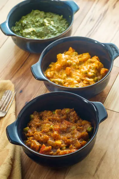 Indian food vegetarian thali including saag paneer bayngan bhurta and vegetable korma