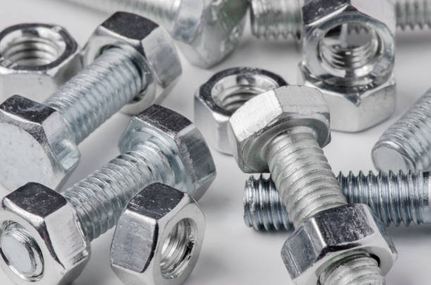 istock Lots of metal bolts and nuts. Tool for fixing. White background 1265232799