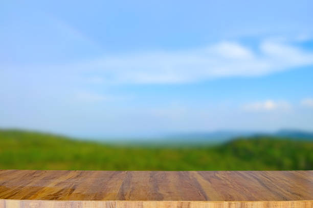 istock Empty wooden table top on blurred nature landscape background 1265233114