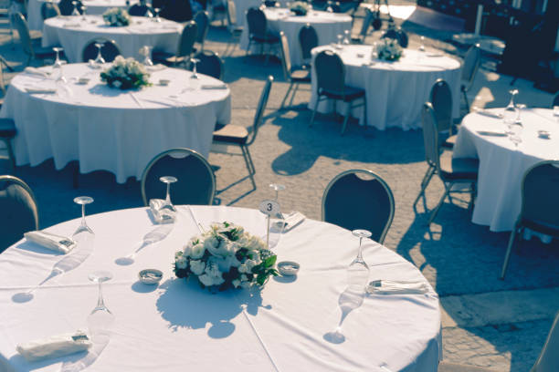 istock Table at a luxury wedding reception. Beautiful flowers on the table. Serving dishes, glass glasses, waiters work 1265233740