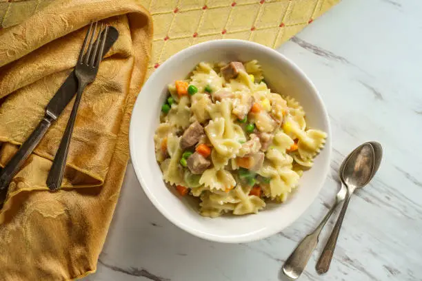 Chicken  pot pie pasta casserole with mixed vegetables and bowtie noodles