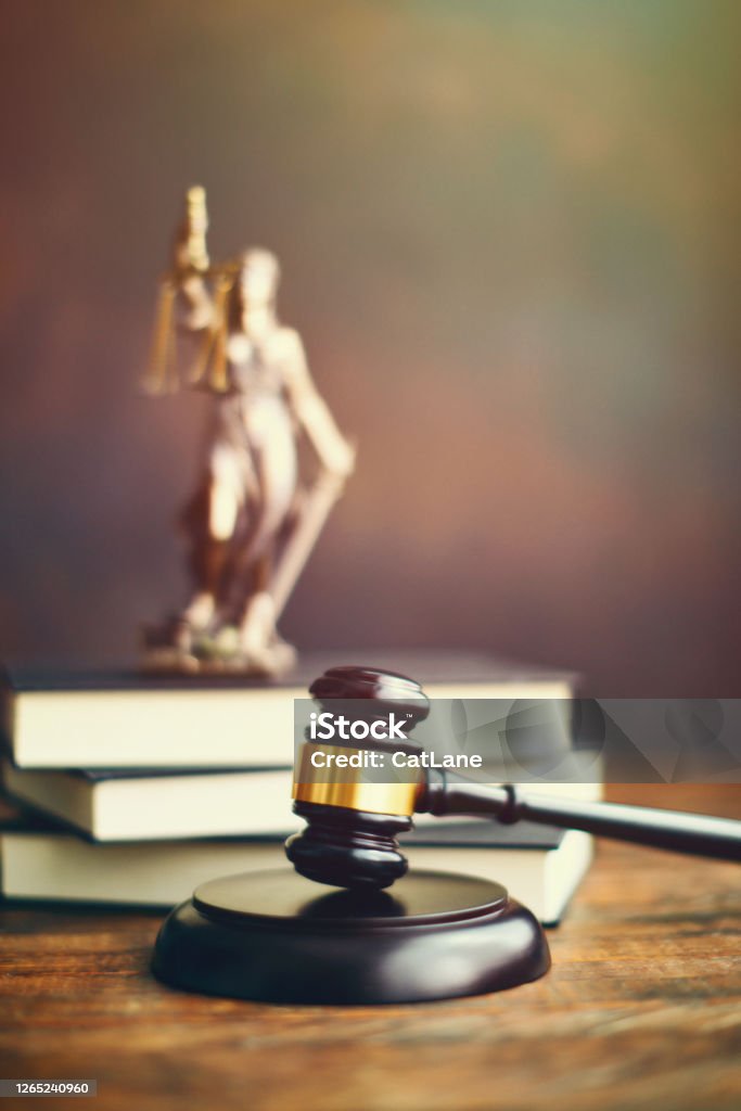Gavel on desk with Lady Justice Gavel on desk with Lady Justice. Law and legal concept Law Stock Photo