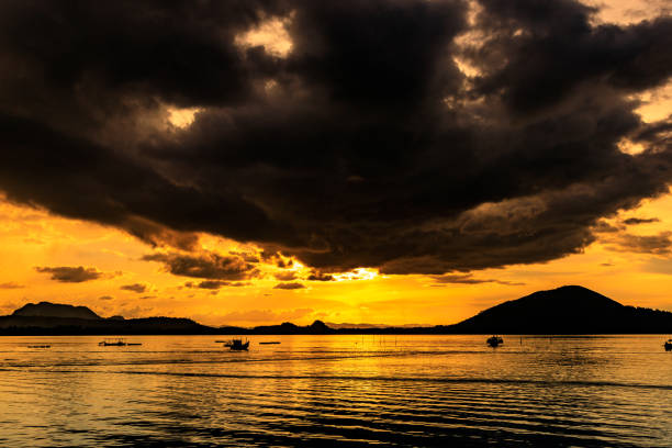 istock Silhouette of sea with dramatic clouds in the sunset light. 1265241616