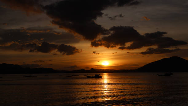 istock Silhouette of sea with dramatic clouds in the sunset light. 1265241626