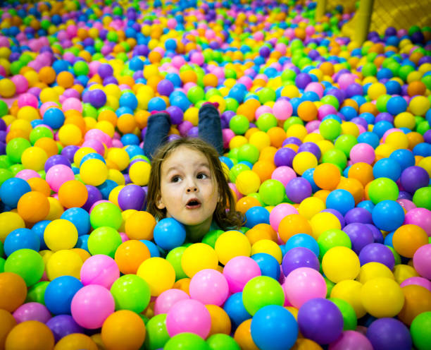 istock Child plays in the pool with balls. One head sticks out 1265241805
