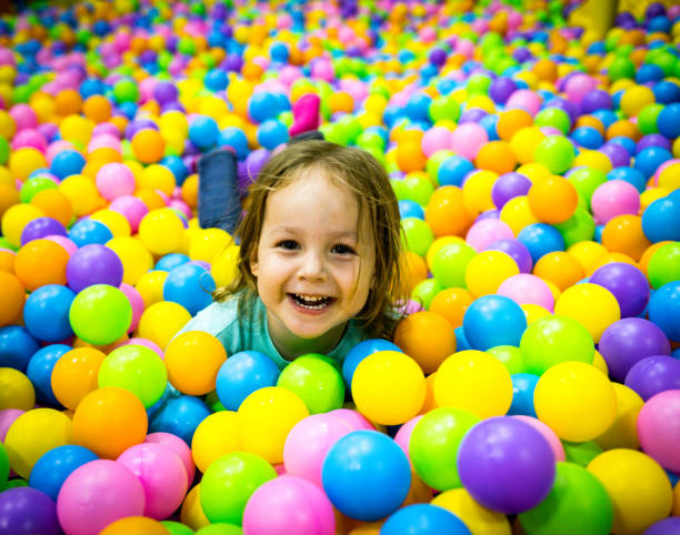istock Child plays in the pool with balls. One head sticks out 1265242368