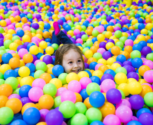 istock Child plays in the pool with balls. One head sticks out 1265242389