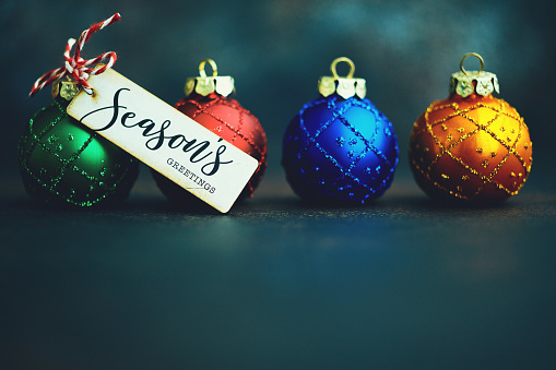 Still Life Background with Vibrant Christmas Ornaments and Holiday Message