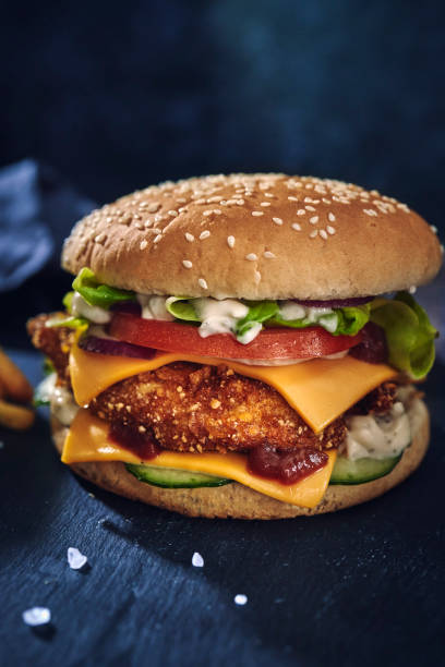 istock Crispy Chicken Burger with Cheese, Tomato, Onions and Lettuce 1265242933
