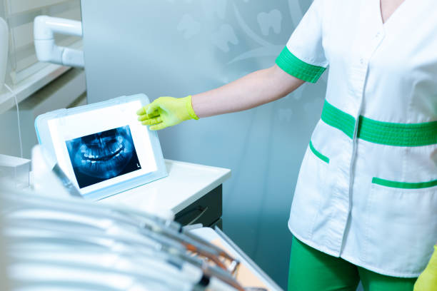 istock Dentist showing xray on film iluminator 1265243303