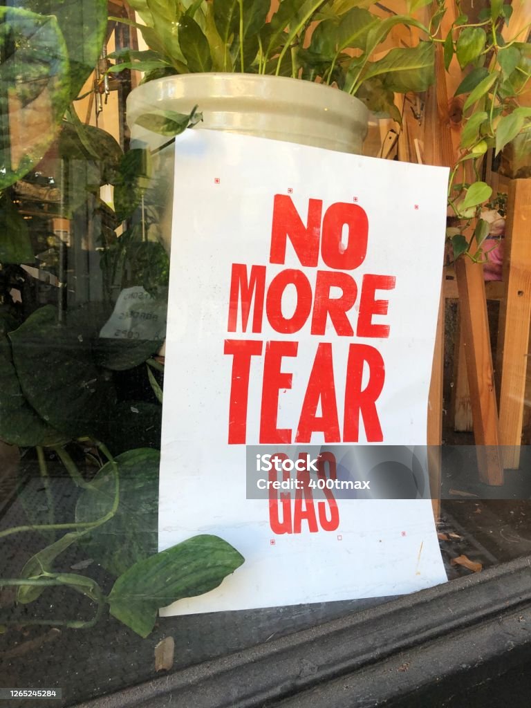 Tear Gas No more tear gas sign in a window. Police Brutality Stock Photo