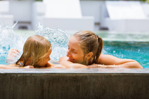 istock Happy people have fun at pool side edge. 1265247138