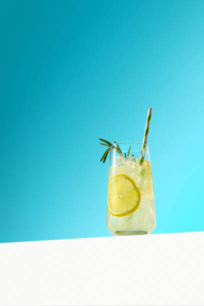 istock Glass ice lemonade with rosemary on blue background. 1265249241