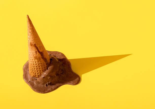 istock Chocolate ice cream in waffle cone upside down. Dropped ice cream 1265249296