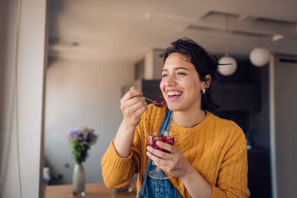 istock Happy girl enjoying fresh pomegranate at home 1265249349