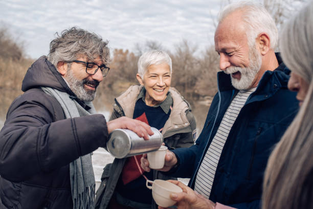 istock Group of happy seniors having fun and enjoying coffee while sailing the river 1265253244