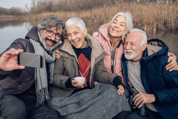 istock Group of joyful seniors sailing the river and taking a selfie 1265253245