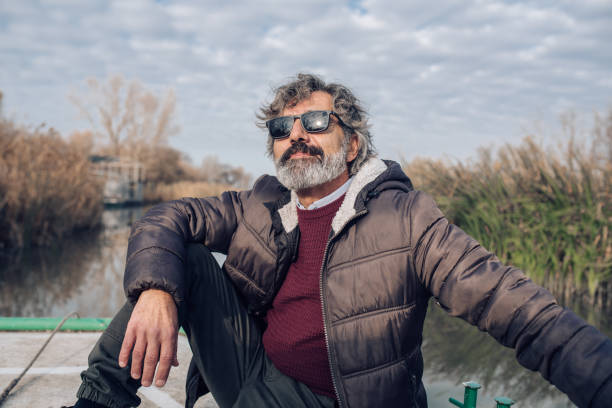 istock Senior man enjoying nature around the river 1265253250
