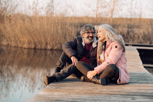 istock Senior couple relaxing on the river dock 1265253337