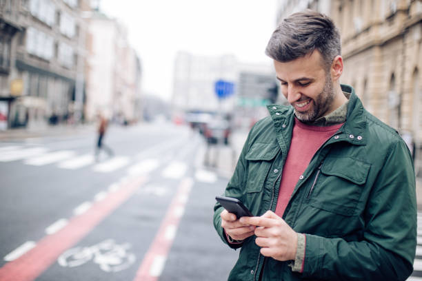 istock Portrait of a man using smartphone on the move 1265253362