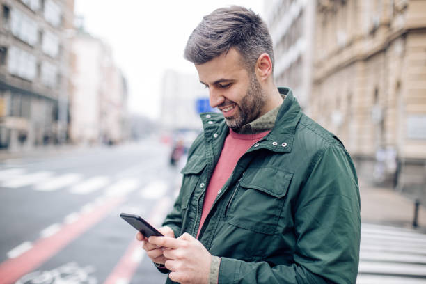 istock Portrait of a man using smartphone on the street 1265253380