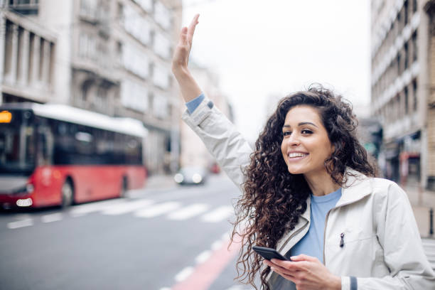 istock Beautiful woman calling a taxi 1265253387