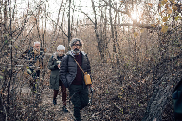 istock Seniors walking through the forest and exploring the nature 1265253400