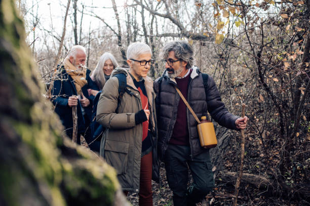 istock Senior friends hiking together 1265253411