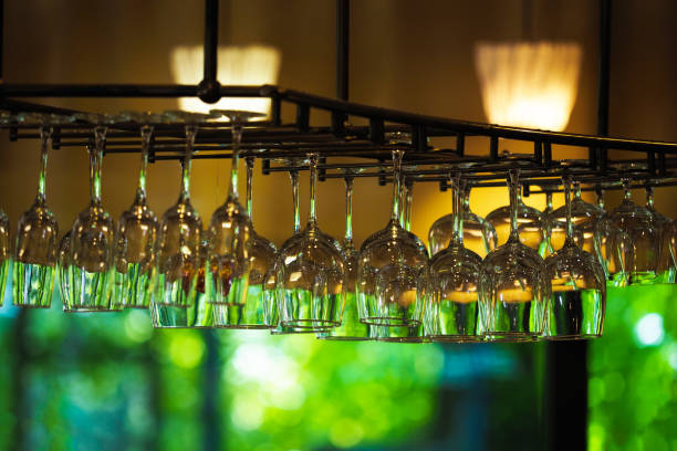 Hanging glasses in a restaurant. Empty glasses for wine above a bar rack