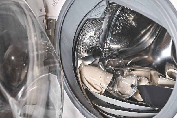 istock Loading dirty dishes into the washing machine. lack of dishwasher. 1265256893