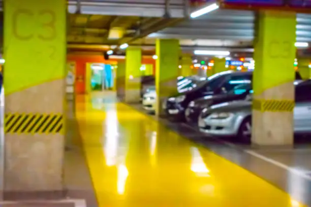 Parking car blurred. Empty road asphalt background in soft focus. Car lot parking space in underground city garage. Interior underground carpark