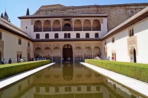 Granada / Spain - July 2019 : Fountain in the interior garden of the Nazaries palaces in La Alhambra Granada